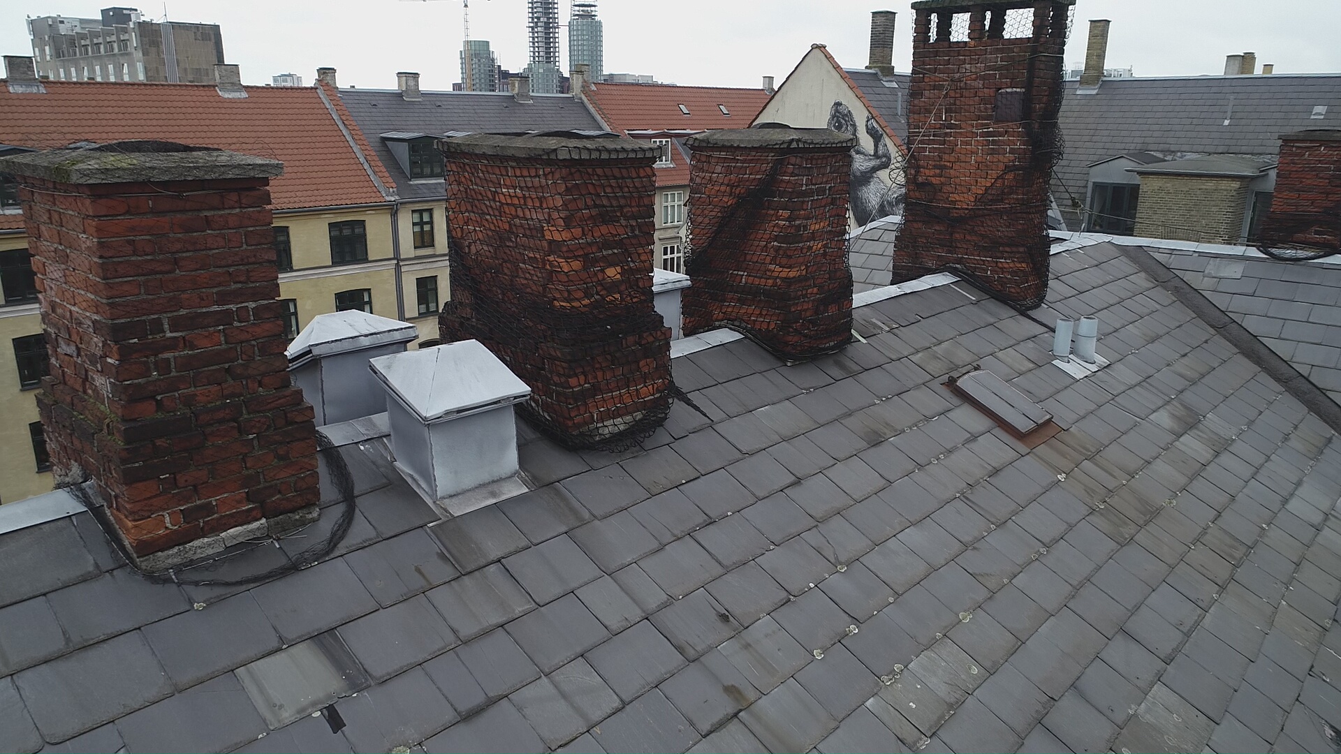 Drone luftfoto af kraftigt nedbrudt murstensskorsten med strukturel hældning — Gentofte